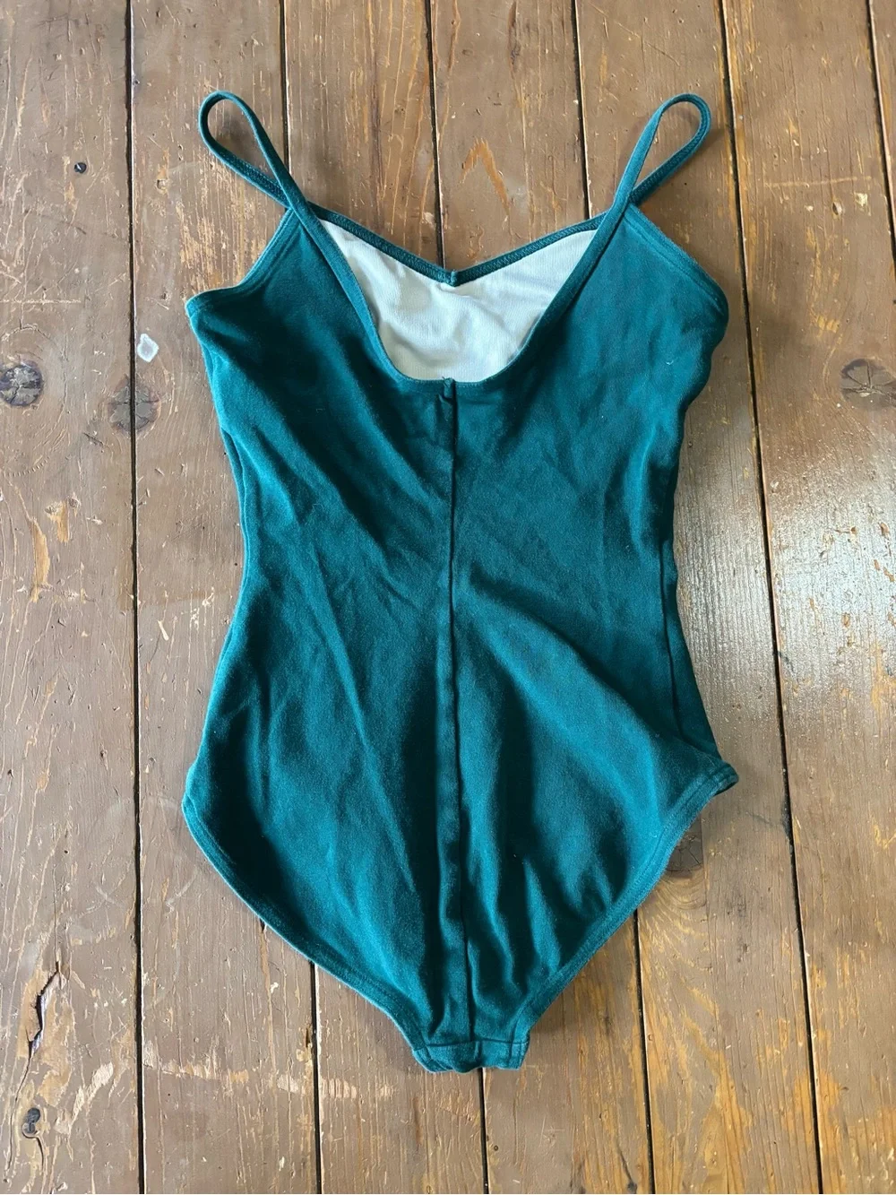 Capezio forest green camisole leotard with a v-neckline and princess seams.